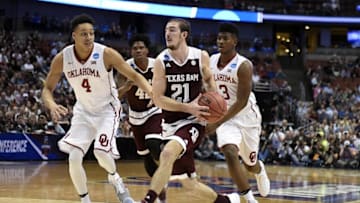 March 24, 2016; Anaheim, CA, USA; Texas A&M Aggies guard Alex Caruso (21) moves to the basket against Oklahoma Sooners center Jamuni McNeace (4) and guard Christian James (3) during the first half of the semifinal game in the West regional of the NCAA Tournament at Honda Center. Mandatory Credit: Richard Mackson-USA TODAY Sports