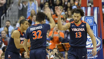 Mar 12, 2016; Washington, DC, USA; Virginia Cavaliers forward Anthony Gill (13) celebrates with guard London Perrantes (32) in the first half against the North Carolina Tar Heels during the championship game of the ACC conference tournament at Verizon Center. Mandatory Credit: Tommy Gilligan-USA TODAY Sports