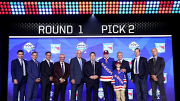 VANCOUVER, BRITISH COLUMBIA - JUNE 21: Kaapo Kakko (fifth from right), second overall pick by the New York Rangers, poses for a photo with team personnel onstage during the first round of the 2019 NHL Draft at Rogers Arena on June 21, 2019 in Vancouver, Canada. (Photo by Dave Sandford/NHLI via Getty Images)