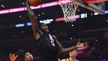 LOS ANGELES, CA - NOVEMBER 30: Montrezl Harrell #5 of the LA Clippers grabs a rebound in front of Donovan Mitchell #45 and Jonas Jerebko #8 of the Utah Jazz during the first half at Staples Center on November 30, 2017 in Los Angeles, California. (Photo by Harry How/Getty Images)