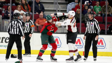 CLEVELAND, OH - DECEMBER 20: Iowa Wild defenceman Hunter Warner (4) and Cleveland Monsters center Sam Vigneault (21) fight during the first period of the American Hockey League game between the Iowa Wild and Cleveland Monsters on December 20, 2017, at Quicken Loans Arena in Cleveland, OH. Cleveland defeated Iowa 5-4 in overtime. (Photo by Frank Jansky/Icon Sportswire via Getty Images)