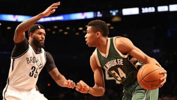 Dec 1, 2016; Brooklyn, NY, USA; Milwaukee Bucks forward Giannis Antetokounmpo (34) drives past Brooklyn Nets forward Trevor Booker (35) during the first quarter at Barclays Center. Mandatory Credit: Anthony Gruppuso-USA TODAY Sports