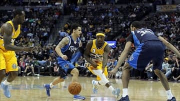 Mar 5, 2014; Denver, CO, USA; Denver Nuggets point guard Ty Lawson (3) passes the ball to power forward J.J. Hickson (7) against Dallas Mavericks power forward Brandan Wright (34) and point guard Shane Larkin (3) in the second quarter at the Pepsi Center. Mandatory Credit: Isaiah J. Downing-USA TODAY Sports