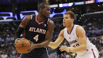 Mar 8, 2014; Los Angeles, CA, USA; Atlanta Hawks forward Paul Millsap (4) posts up on Los Angeles Clippers forward Blake Griffin (32) during the second quarter at Staples Center. Mandatory Credit: Kelvin Kuo-USA TODAY Sports