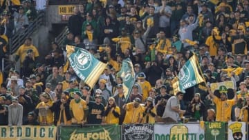 Oct 10, 2013; Oakland, CA, USA; Oakland Athletics fans wave banners in the outfield during the ninth inning in game five of the American League divisional series playoff baseball game at O.co Coliseum. The Detroit Tigers defeated the Oakland Athletics 3-0. Mandatory Credit: Ed Szczepanski-USA TODAY Sports