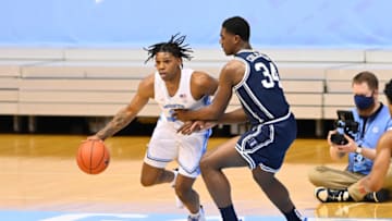 Mar 6, 2021; Chapel Hill, North Carolina, USA; North Carolina Tar Heels guard Caleb Love (2) with the ball as Duke Blue Devils forward Henry Coleman III (34) defends in the second half at Dean E. Smith Center. Mandatory Credit: Bob Donnan-USA TODAY Sports