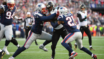 Jan 21, 2018; Foxborough, MA, USA; Jacksonville Jaguars running back Leonard Fournette (27) runs the ball against New England Patriots cornerback Malcolm Butler (21) and outside linebacker Kyle Van Noy (53) during the second quarter in the AFC Championship Game at Gillette Stadium. Mandatory Credit: Robert Deutsch-USA TODAY Sports