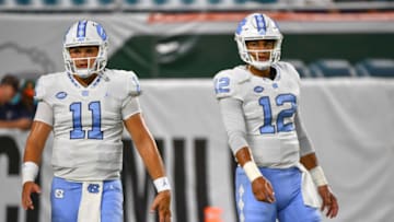 MIAMI, FL - SEPTEMBER 27: Nathan Elliott #11 and Chazz Surratt #12 of the North Carolina Tar Heels warm up before the game against the Miami Hurricanes at Hard Rock Stadium on September 27, 2018 in Miami, Florida. (Photo by Mark Brown/Getty Images)