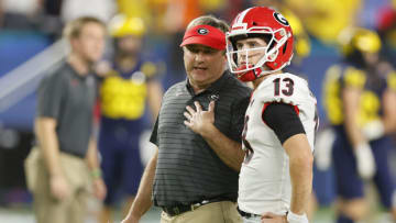 MIAMI GARDENS, FLORIDA - DECEMBER 31: Stetson Bennett #13 of the Georgia Bulldogs talks with head coach Kirby Smart prior to the game against the Michigan Wolverines in the Capital One Orange Bowl for the College Football Playoff semifinal game at Hard Rock Stadium on December 31, 2021 in Miami Gardens, Florida. (Photo by Michael Reaves/Getty Images)