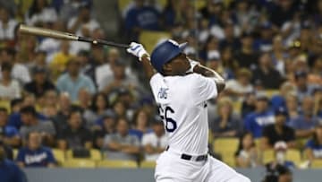 Jul 29, 2016; Los Angeles, CA, USA; Los Angeles Dodgers right fielder Yasiel Puig (66) hits a sacrifice fly to advance a runner against the Arizona Diamondbacks during the seventh inning at Dodger Stadium. Mandatory Credit: Richard Mackson-USA TODAY Sports
