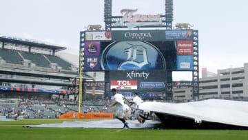 DETROIT, MI - AUGUST 29: Comerica Park ground crew covers the infield as rain falls during the fifth inning of the Detroit Tigers game against the Toronto Blue Jays on August 29, 2021, in Detroit, Michigan. (Photo by Duane Burleson/Getty Images)