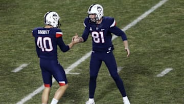 BOSTON, MA - NOVEMBER 18: Michael Tarbutt #40 of the Connecticut Huskies celebrates with Brett Graham #81after scoring a field goal during the first quarter of their game against the Boston College Eagles at Fenway Park on November 18, 2017 in Boston, Massachusetts. (Photo by Maddie Meyer/Getty Images)