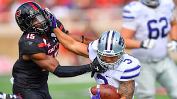 LUBBOCK, TX - NOVEMBER 4: Dalvin Warmack #3 of the Kansas State Wildcats tries to break away from Vaughnte Dorsey #15 of the Texas Tech Red Raiders during the first half of the game on November 4, 2017 at Jones AT&T Stadium in Lubbock, Texas. (Photo by John Weast/Getty Images)