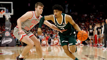 COLUMBUS, OH - FEBRUARY 12: Jaden Akins #3 of the Michigan State Spartans drives the ball past Sean McNeil #4 of the Ohio State Buckeyes during the second half of the game at the Jerome Schottenstein Center on February 12, 2023 in Columbus, Ohio. Michigan State defeated Ohio State 62-41. (Photo by Kirk Irwin/Getty Images)