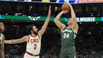 Dec 6, 2021; Milwaukee, Wisconsin, USA; Milwaukee Bucks guard Pat Connaughton (24) puts a shot up against Cleveland Cavaliers guard Ricky Rubio (3) in the second half at Fiserv Forum. Mandatory Credit: Michael McLoone-USA TODAY Sports