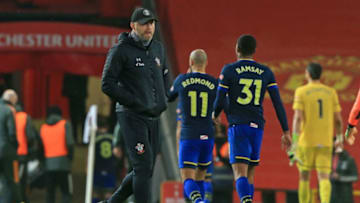 Southampton's Austrian manager Ralph Hasenhuttl (C) walks on the pitch after the English Premier League football match between Manchester United and Southampton at Old Trafford in Manchester, north west England, on February 2, 2021. - Manchester United won the game 9-0. (Photo by Lindsey Parnaby / POOL / AFP) / RESTRICTED TO EDITORIAL USE. No use with unauthorized audio, video, data, fixture lists, club/league logos or 'live' services. Online in-match use limited to 120 images. An additional 40 images may be used in extra time. No video emulation. Social media in-match use limited to 120 images. An additional 40 images may be used in extra time. No use in betting publications, games or single club/league/player publications. / (Photo by LINDSEY PARNABY/POOL/AFP via Getty Images)