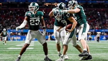 Michigan State player celebrate with a touchdown scored by Michigan State linebacker Cal Haladay (27) during the second half of the 31-21 win over Pittsburgh in the Peach Bowl at the Mercedes-Benz Stadium in Atlanta on Thursday, Dec. 30, 2021.