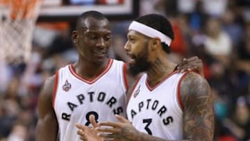 Jan 30, 2016; Toronto, Ontario, CAN; Toronto Raptors center Bismack Biyombo (8) shares a laugh with forward James Johnson (3) against the Detroit Pistons at Air Canada Centre. The Raptors beat the Pistons 111-107. Mandatory Credit: Tom Szczerbowski-USA TODAY Sports