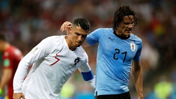 SOCHI, RUSSIA - JUNE 30: Cristiano Ronaldo of Portugal helps Edinson Cavani of Uruguay off the pitch after he gets injured during the 2018 FIFA World Cup Russia Round of 16 match between Uruguay and Portugal at Fisht Stadium on June 30, 2018 in Sochi, Russia. (Photo by Julian Finney/Getty Images)