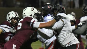 Seaholm Maple Jake LaBarre, left, goes up against Oak Park offensive lineman Rayshaun Benny.Seaholmfootballvsoakpark13