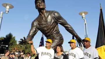 Sep 16, 2015; Pittsburgh, PA, USA; The family of Pittsburgh Pirates former right fielder Roberto Clemente (not pictured) including Roberto Clemente Jr. (L) and Vera Clemente (LC) and Ricky Clemente (RC) and Luis Clemente (R) pose with the Clemente statue outside of PNC Park before the Pirates host the Chicago Cubs. Mandatory Credit: Charles LeClaire-USA TODAY Sports