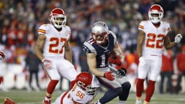 Jan 16, 2016; Foxborough, MA, USA; New England Patriots wide receiver Julian Edelman (11) carries the ball as Kansas City Chiefs inside linebacker Derrick Johnson (56) defends during the second half in the AFC Divisional round playoff game at Gillette Stadium. Mandatory Credit: David Butler II-USA TODAY Sports