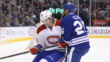 Jan 23, 2016; Toronto, Ontario, CAN; Montreal Canadiens defenseman Jeff Petry (26) checks Toronto Maple Leafs left wing Rich Clune (25) at Air Canada Centre. The Canadiens beat the Maple Leafs 3-2. Mandatory Credit: Tom Szczerbowski-USA TODAY Sports