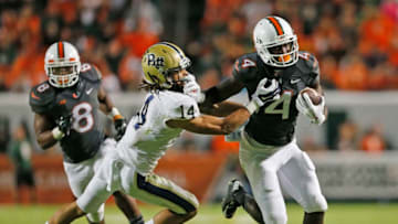MIAMI GARDENS, FL - NOVEMBER 29: Avonte Maddox #14 of the Pittsburgh Panthers defends against Phillip Dorsett #4 of the Miami Hurricanes as he runs with the ball during third quarter action on November 29, 2014 at Sun Life Stadium in Miami Gardens, Florida. Pittsburgh defeated Miami 35-23. (Photo by Joel Auerbach/Getty Images)