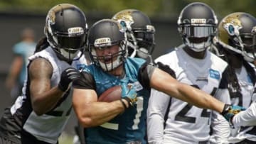 Jun 17, 2014; Jacksonville, FL, USA; Jacksonville Jaguars running back Toby Gerhart (21) tries to run by safety Winston Guy (left) during the first day of minicamp at Florida Blue Health and Wellness Practice Fields. Mandatory Credit: Phil Sears-USA TODAY Sports