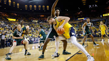 Mar 1, 2022; Ann Arbor, Michigan, USA; aMichigan Wolverines center Hunter Dickinson (1) is defended by Michigan State Spartans forward Julius Marble II (34) in the first half t Crisler Center. Mandatory Credit: Rick Osentoski-USA TODAY Sports