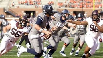 Oct 29, 2016; Champaign, IL, USA; Illinois Fighting Illini quarterback Jeff George Jr. (3) is chased by Minnesota Golden Gophers linebacker Nick Rallis (56) and defensive lineman Steven Richardson (96)during the 4th quarter at Memorial Stadium. Minnesota beat Illinois 40 to 17. Mandatory Credit: Mike Granse-USA TODAY Sports