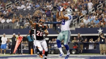 Aug 24, 2013; Arlington, TX, USA; Dallas Cowboys wide receiver Miles Austin (19) catches a touchdown pass while defended by Cincinnati Bengals strong safety Taylor Mays (26) in the second quarter at AT