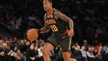NBA big man John Collins #20 of the Atlanta Hawks dribbles the ball (Photo by Sarah Stier/Getty Images)