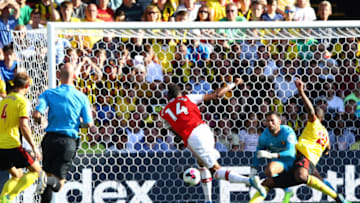 WATFORD, ENGLAND - SEPTEMBER 15: Pierre-Emerick Aubameyang of Arsenal (14) scores his team's first goal past Ben Foster of Watford during the Premier League match between Watford FC and Arsenal FC at Vicarage Road on September 15, 2019 in Watford, United Kingdom. (Photo by Julian Finney/Getty Images)