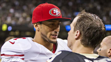NEW ORLEANS, LA - NOVEMBER 17: Colin Kaepernick #7 of the San Francisco 49ers talks after the game to Dree Brews #9 of the New Orleans Saints at Mercedes-Benz Superdome on November 17, 2013 in New Orleans, Louisiana. The Saints defeated the 49ers 23-20. (Photo by Wesley Hitt/Getty Images)