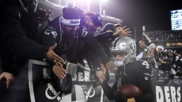 OAKLAND, CA - DECEMBER 24: Derek Carr #4 of the Oakland Raiders greets fans in the stands after their 27-14 win over the Denver Broncos in what may be the final Raiders game at the Oakland-Alameda County Coliseum on December 24, 2018 in Oakland, California. (Photo by Robert Reiners/Getty Images)
