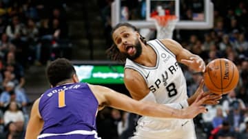SAN ANTONIO, TX - JANUARY 29: Patty Mills #8 of the San Antonio Spurs loses control of the ball against Devin Booker #1 of the Phoenix Suns during an NBA game held January 29, 2019 at the AT&T Center in San Antonio, Texas. The Spurs won 126-124. NOTE TO USER: User expressly acknowledges and agrees that, by downloading and or using this photograph, User is consenting to the terms and conditions of the Getty Images License Agreement. (Photo by Edward A. Ornelas/Getty Images)