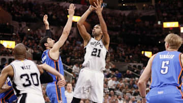 Apr 12, 2016; San Antonio, TX, USA; San Antonio Spurs power forward Tim Duncan (21) shoots the ball over Oklahoma City Thunder center Enes Kanter (11, left) during the first half at AT&T Center. Mandatory Credit: Soobum Im-USA TODAY Sports