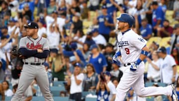 LOS ANGELES, CA - JUNE 08: Freddie Freeman #5 of the Atlanta Braves looks on as Yasmani Grandal #9 of the Los Angeles Dodgers rounds the bases after hitting a solo home run in the second inning of the game at Dodger Stadium on June 8, 2018 in Los Angeles, California. (Photo by Jayne Kamin-Oncea/Getty Images)