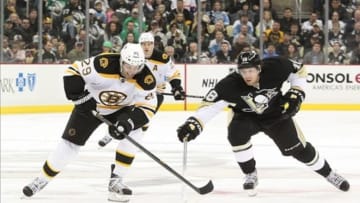 March 17, 2013; Pittsburgh, PA, USA; Boston Bruins left wing Jay Pandolfo (29) breaks up ice with the puck as Pittsburgh Penguins left wing James Neal (18) poke checks him from behind during the third period at the CONSOL Energy Center. The Pittsburgh Penguins won 2-1. Mandatory Credit: Charles LeClaire-USA TODAY Sports