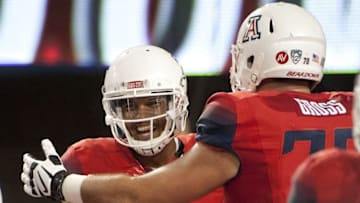Sep 19, 2015; Tucson, AZ, USA; Arizona Wildcats quarterback Brandon Dawkins (13) and offensive lineman T.D. Gross (70) celebrate after a touchdown during the fourth quarter against the Northern Arizona Lumberjacks at Arizona Stadium. Arizona won 77-13. Mandatory Credit: Casey Sapio-USA TODAY Sports