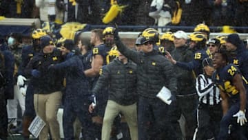 Michigan coach Jim Harbaugh and his team celebrate after Michigan's 42-27 win over Ohio State on Saturday, Nov. 27, 2021, at Michigan Stadium.Michigan Ohio