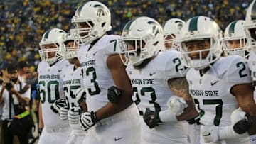 ANN ARBOR, MI - OCTOBER 07: Tyriq Thompson #17 of the Michigan State Spartans leads the team onto the field prior to the start of the game against the Michigan Wolverines at Michigan Stadium on October 7, 2017 in Ann Arbor, Michigan. (Photo by Leon Halip/Getty Images)
