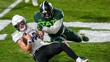 Michigan State's Jacub Panasiuk, right, tackles Northwestern's quarterback Peyton Ramsey during the third quarter on Saturday, Nov. 28, 2020, at Spartan Stadium in East Lansing.201128 Msu Northwestern 130a