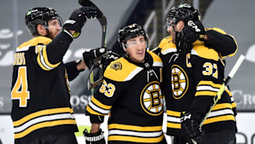 Mar 11, 2021; Boston, Massachusetts, USA; Boston Bruins defenseman Jarred Tinordi (84) center Brad Marchand (63) celebrate a short handed goal by center Patrice Bergeron (37) during the first period against the New York Rangers at TD Garden. Mandatory Credit: Bob DeChiara-USA TODAY Sports