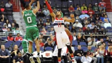 Jan 25, 2016; Washington, DC, USA; Boston Celtics guard Avery Bradley (0) shoots over Washington Wizards guard Garrett Temple (17) during the first half at Verizon Center. Mandatory Credit: Brad Mills-USA TODAY Sports