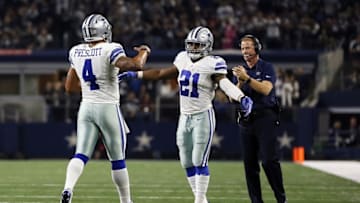 Dec 18, 2016; Arlington, TX, USA; Dallas Cowboys quarterback Dak Prescott (4) celebrates with running back Ezekiel Elliott (21) and head coach Jason Garrett after scoring a touchdown against the Tampa Bay Buccaneers at AT&T Stadium. Mandatory Credit: Tim Heitman-USA TODAY Sports
