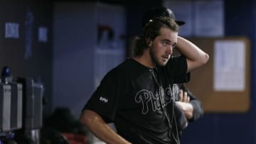 MIAMI, FLORIDA - AUGUST 25: Aaron Nola #27 of the Philadelphia Phillies reacts in the dugout during a game against the Miami Marlins at Marlins Park on August 25, 2019 in Miami, Florida. Teams are wearing special color schemed uniforms with players choosing nicknames to display for Players' Weekend. (Photo by Michael Reaves/Getty Images)