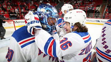 RALEIGH, NC - MARCH 31: Henrik Lundqvist #30 of the New York Rangers is congratulated for his win by teammate Mats Zuccarello #36 during an NHL game against the Carolina Hurricanes on March 31, 2018 at PNC Arena in Raleigh, North Carolina. (Photo by Gregg Forwerck/NHLI via Getty Images)