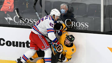 Mar 13, 2021; Boston, Massachusetts, USA; New York Rangers defenseman Ryan Lindgren (55) checks Boston Bruins center David Krejci (46) into the boards during the second period at the TD Garden. Mandatory Credit: Brian Fluharty-USA TODAY Sports